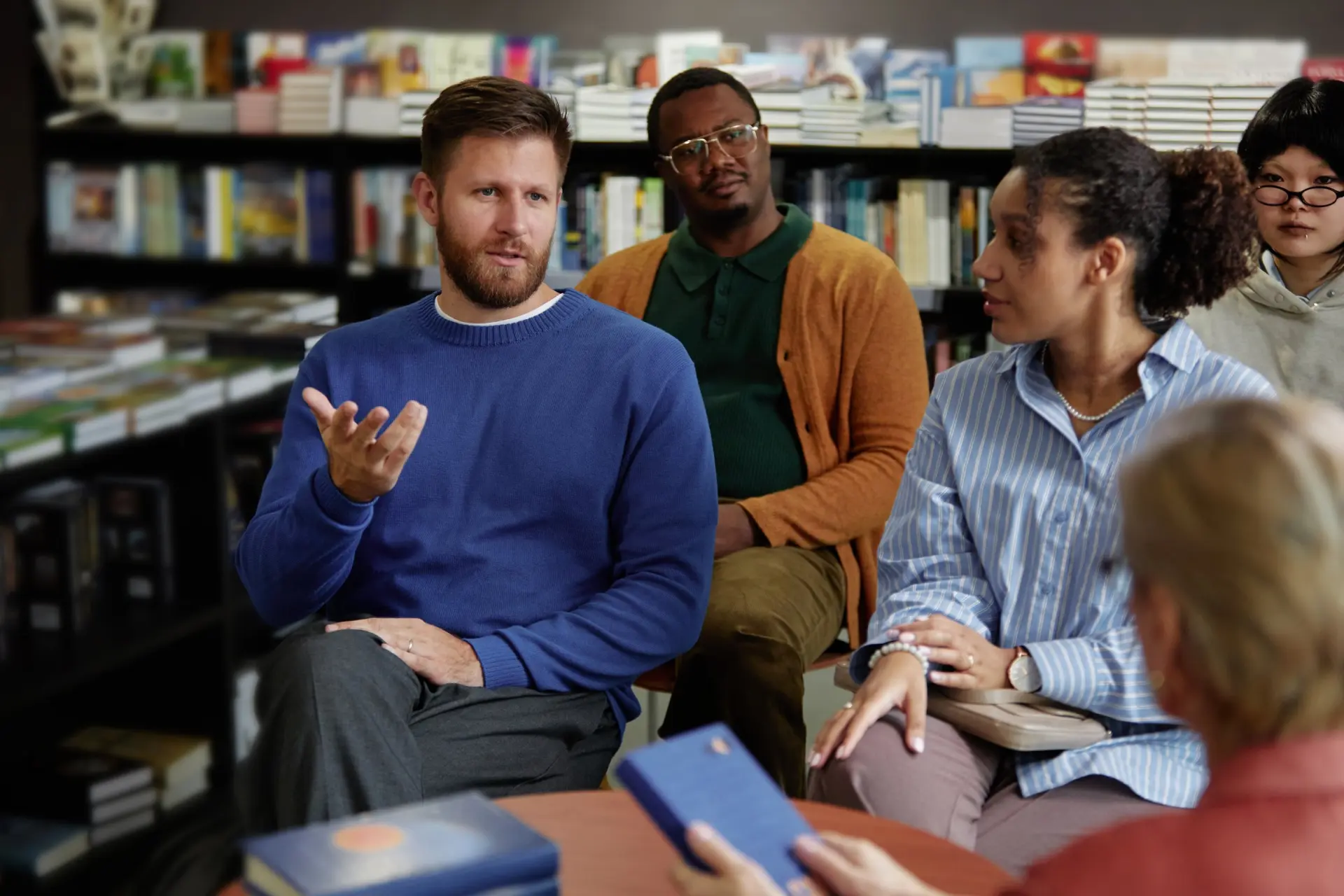 Group discussion with diverse participants in a bookstore setting